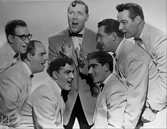 Bill Haley and the Comets in 1956. Left to right: Rudy Pompilli, Billy Williamson, Al Rex, Bill Haley, Johnny Grande, Ralph Jones, and Franny Beecher