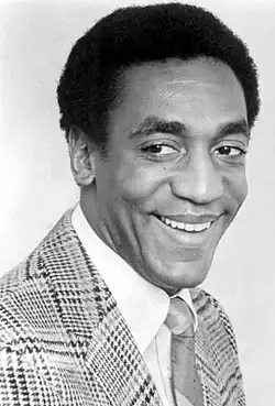 Black-and-white head shot of Cosby smiling