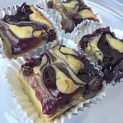 4 single servings of butter mochi marbled with a blueberry filling.