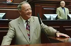 Bobby Bowden in a suit speaking.