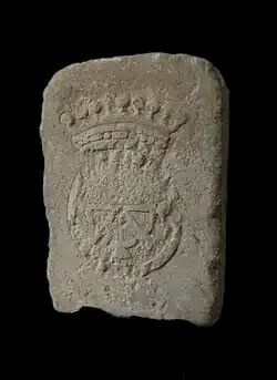 Raised stone on a black background, marked with a partially hammered crowned wheel.