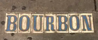 Tiles in the sidewalk mark many streets in the older neighborhoods of New Orleans, Louisiana