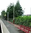 Looking down the platform, away from the station building. The posts with the yellow bands are for new CCTV equipment for use by train drivers.