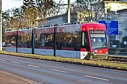 Red and white four-section tram