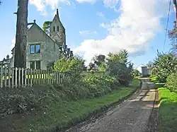 A former church, now converted into a house seen from the east. At the far end is the preserved tower, with a saddleback roof