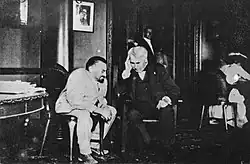 Two men sitting indoors