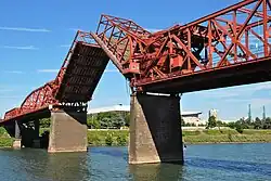 Red metal bridge with draw bridge section raised