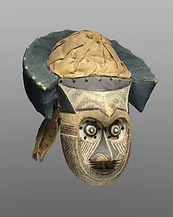 Pwoom Itok mask; late 19th century; 39.1 x 28.6 x 29.8 cm (153⁄8 x 111⁄4 x 113⁄4 in.); Brooklyn Museum (USA). This mask may have represented a wise older man at boys' initiations. One of the principal Kuba dance masks is called pwoom itok. The chief identifying characteristic is the shape of the eyes, whose centers are cones surrounded by holes through which the wearer sees.
