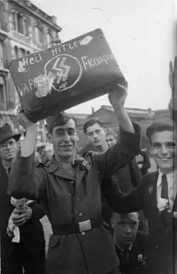 French SS volunteers in uniform walking along a Paris street