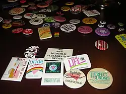 An image of an array of LGBTQIA+ buttons of varying sizes and colour.