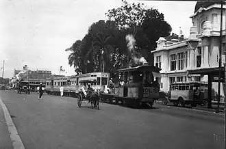 The Post Savings Bank located on the Molenvliet in the center of Batavia with busy tram traffic.