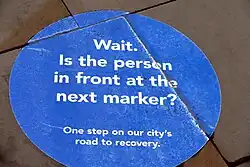 A circular blue sign stating "Wait"