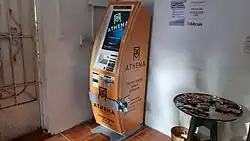 A photograph of an orange Athena Bitcoin cryptocurrency ATM