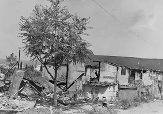 A simply built shack, largely reduced to rubble