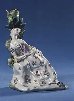 A small procelain statue of a female figure