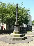 The Canongate Cross in Edinburgh, topped by a cross symbolising the former ecclesiastical burgh