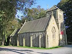 A stone chapel with a small tower surmounted by a pyramidal roof