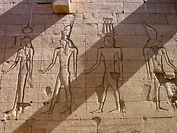 a relief from the temple of Kalabsha, the center right god is wearing a hemhem