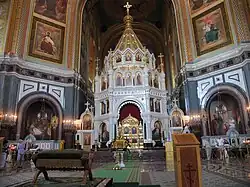 An ornate altar surrounded by several iconographic depictions of saints.