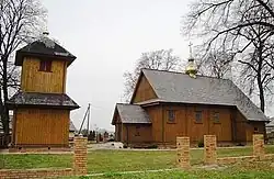 General view of the church with a bell tower on the left
