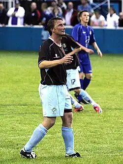 Chris Brass standing on a grass field