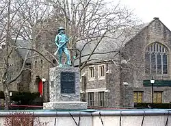 Looking northeast at statue and Community Church of the Circle in Mount Vernon on a cloudy afternoon