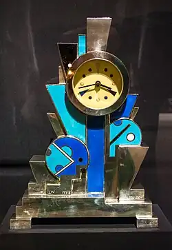 Constructivist influences – Clock, decorated with flat geometric shapes, by Jean Goulden (1928), silvered bronze with enamel, Stephen E. Kelly Collection[67]