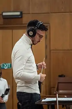 Italian composer Stefano D'Amico conducting Symphonic Orchestra in a Studio