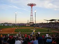 The baseball field inside the Maimonides Park baseball stadium. The Parachute Jump is behind the stadium.