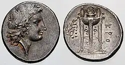 An ancient Greek coin c. 330–300 BC. found in Croton, South Italy with the head of Apollo (left) and ornate tripod (right)