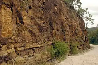 Cutting made by convict workers who would hammer a crowbar-like 'jumperbar' into the rock, fill the hole with gunpowder, plug the hole and ignite it; visible are metre-long 'half holes' that remained after the rock face was blown away