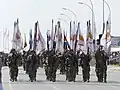 Flag Carriers of the Cypriot National Guard marching in formation during the Independence day parade.