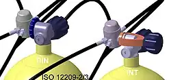 Tops of two cylinders showing regulators connected via DIN and yoke connectors