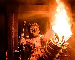 Masked figure with fire