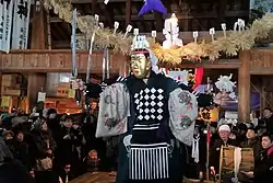 Men with golden mask holding a sword.