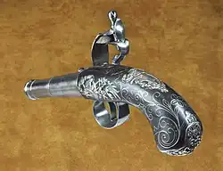 A Queen Anne pistol by Turvey of London with exceptional silver decoration