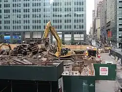 A machine moves demolition debris