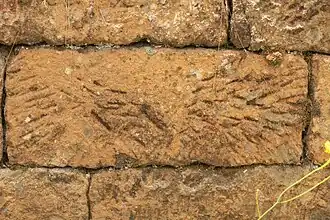 Convict-built embankment, Mount McQuoid, Great North Road, Bucketty, NSW. Distinctive markings on cut stones have been used in archaeological studies to estimate the number of convicts in an 'ironed-gang' i.e. offenders sentenced to work in chains, or other metal restraining devices, on heavy labouring tasks like road-making. There are recognisable and recurring patterns, attributable to individual stone-cutters.
