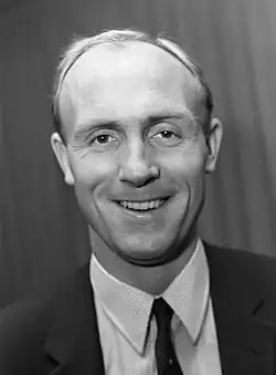 A black-and-white photograph of a smiling Don Howe, who played for Arsenal.