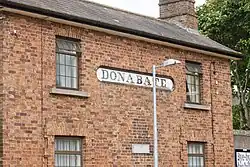 A close up of the historical train station house depicting the sign "Donabate"