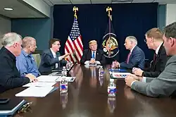 President Donald J. Trump, joined by Texas Gov. Gregg Abbott, Lt. Gov. Dan Patrick and FEMA officials, attends a briefing on the continuing Hurricane Harvey relief and recovery efforts, during a meeting in the Signature Flight Support facility at Dallas Love Field, Wednesday, October 25, 2017, in Dallas, Texas. Gov. Abbott thanked President Trump for his commitment to Texas.