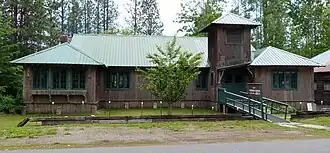Photograph of Dover Church, a one-story, rustic building with cedar bark siding