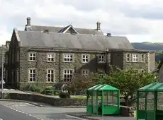 small two-storey building of flint and sandstone