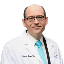 Photograph of Michael Greger in a white coat and brightly colored tie with a transparent background