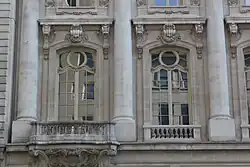 French windows on the second story, separated by round columns