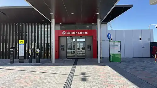 Entrance to a station building with sliding glass doors