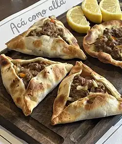 Empanadas arabes, open faced like sfiha and served with lemons
