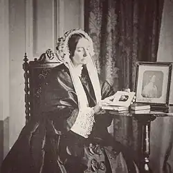 Empress Amélie of Brazil wearing a mobcap with lappets hanging down on each side of her neck
