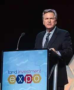 Eric O'Keefe speaking at a lectern.