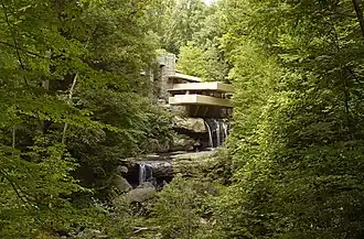 Facade of the Fallingwater as seen from below a waterfall